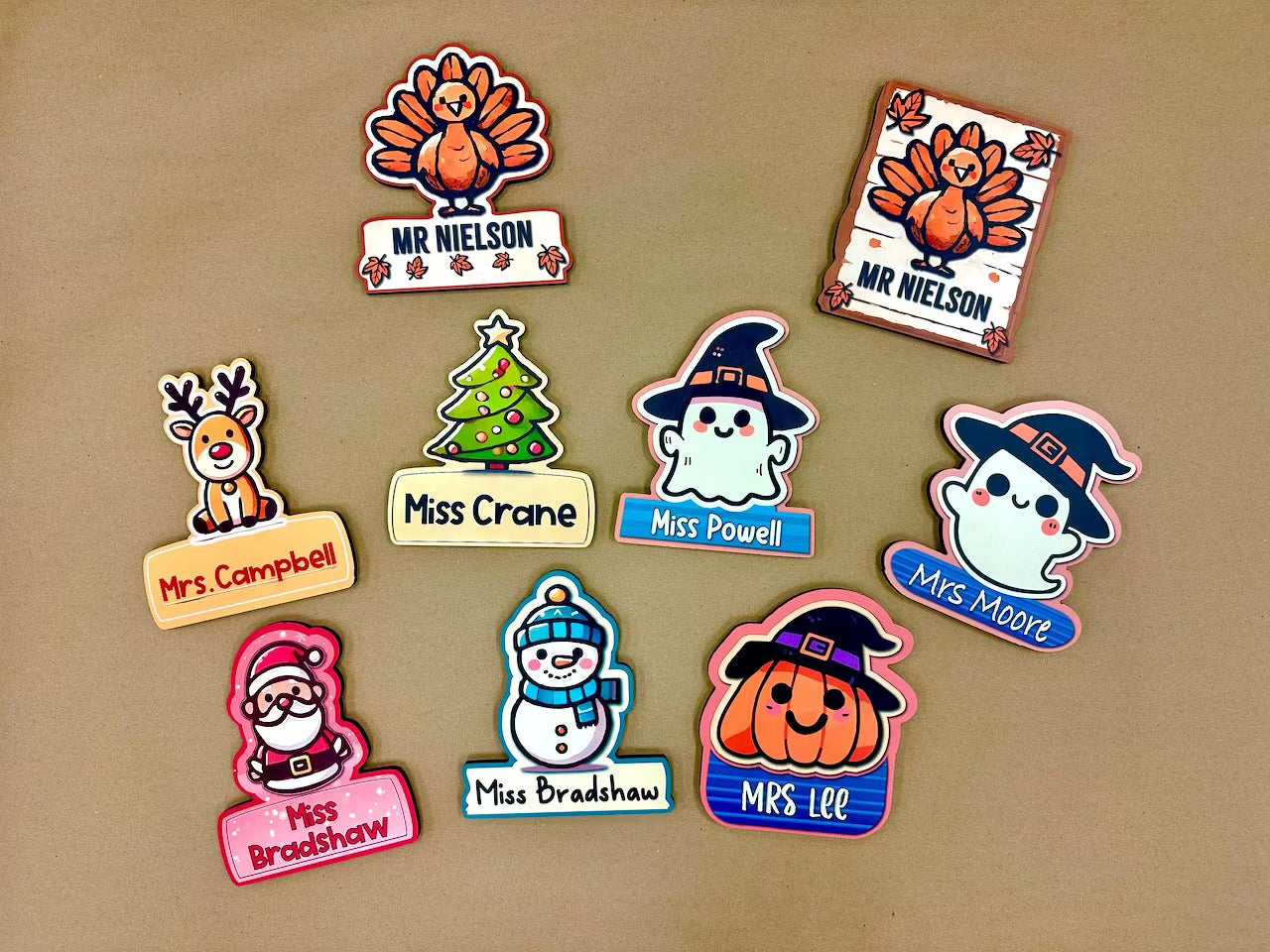 Collection of holiday-themed desk signs by Creative Curbside, featuring Thanksgiving, Christmas, and Halloween designs, displayed together on a brown background.