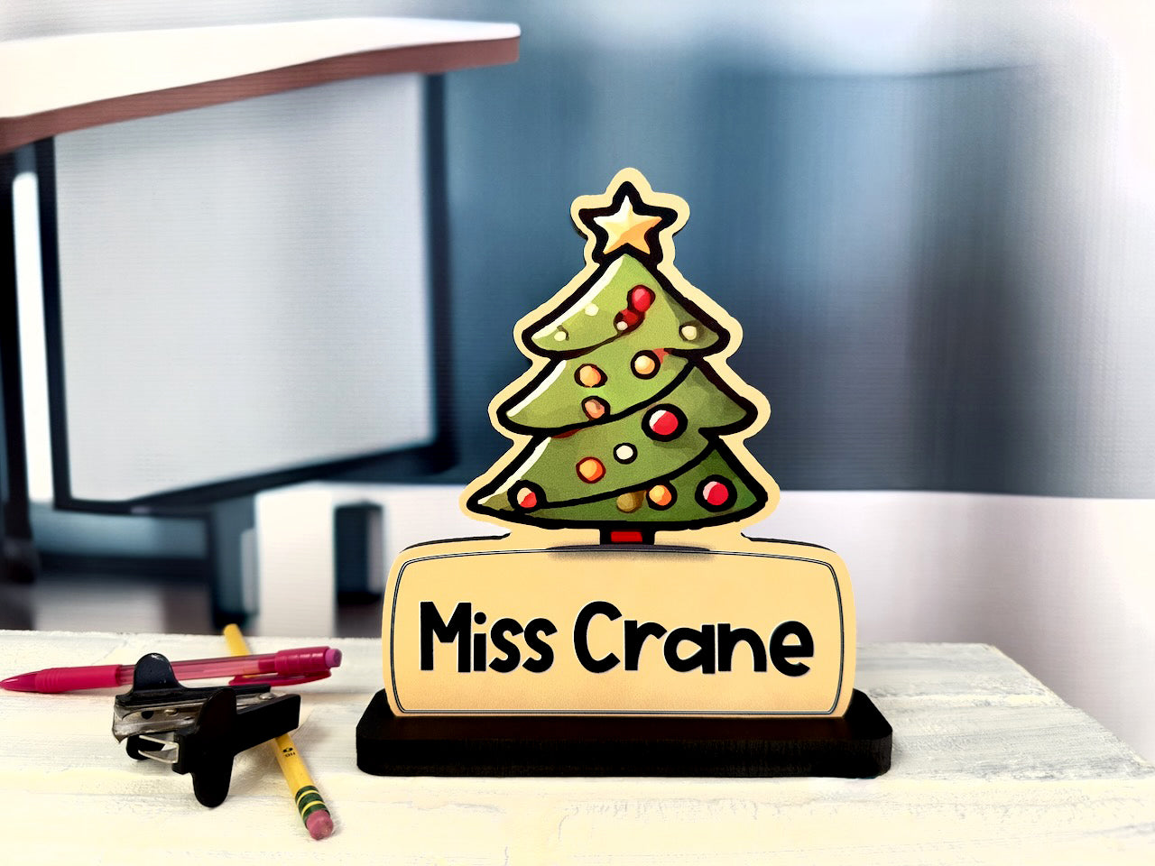 Christmas-themed custom name sign featuring 'Miss Crane' with a decorated tree design placed on a desk, perfect for classroom or holiday decor.