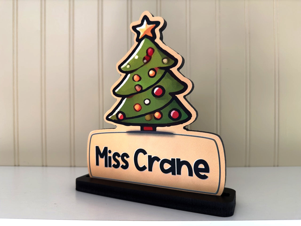 Side view of a Christmas-themed name sign with a festive tree and the name 'Miss Crane', ideal for holiday desk decor or gifts.