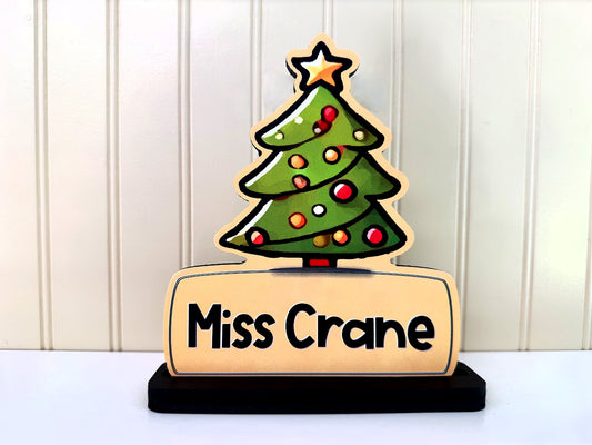 Front view of a personalized Christmas tree name sign with 'Miss Crane', featuring colorful ornaments and a star topper, perfect for holiday decor.