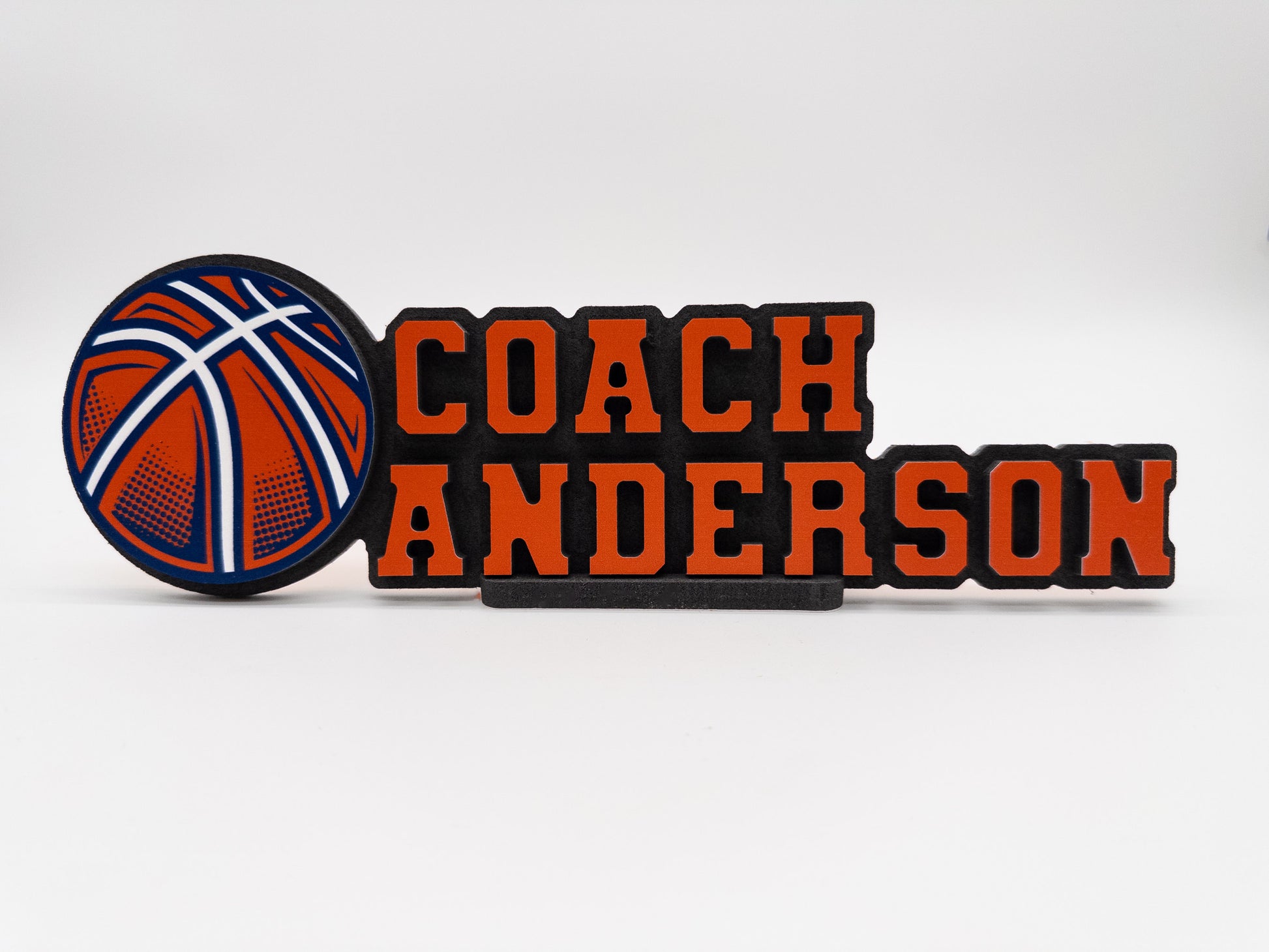 Personalized desk sign for Coach Anderson featuring a basketball design, ideal for displaying on an office desk.