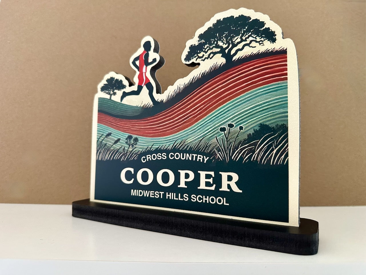 Angled view of custom cross country desk sign featuring a male runner, name Cooper, and Midwest Hills School displayed.