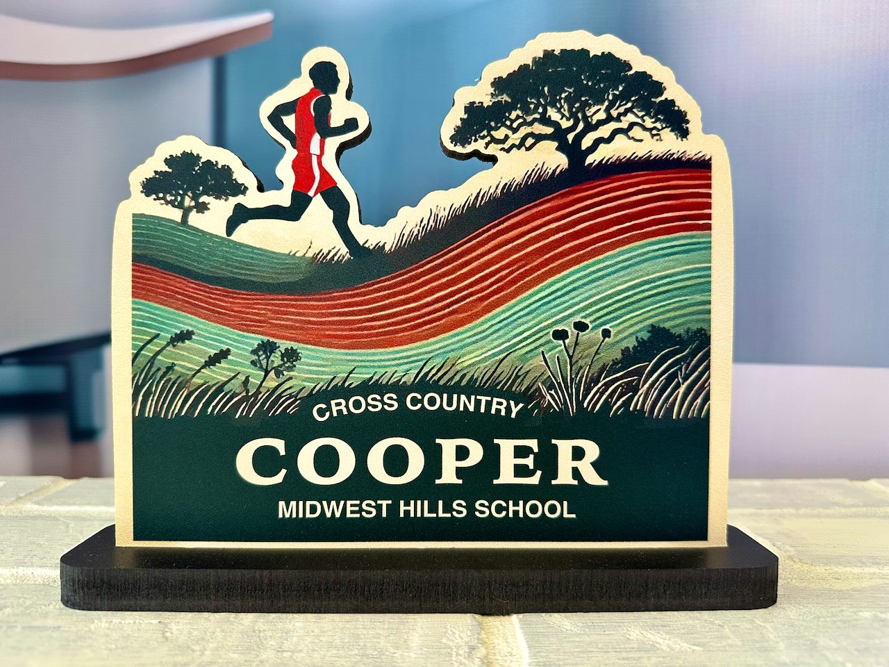 Front view of personalized cross country sign with male runner silhouette and scenic background, labeled Cooper - Midwest Hills School.