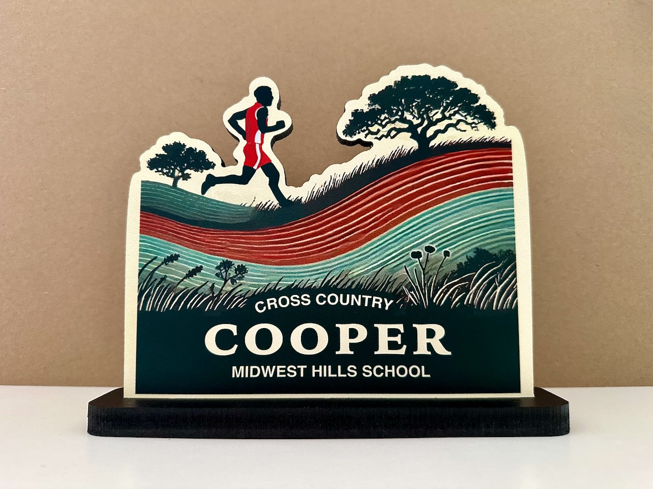 Custom cross country desk sign featuring a male runner silhouette on scenic background with tree and hills, labeled Cooper - Midwest Hills School.