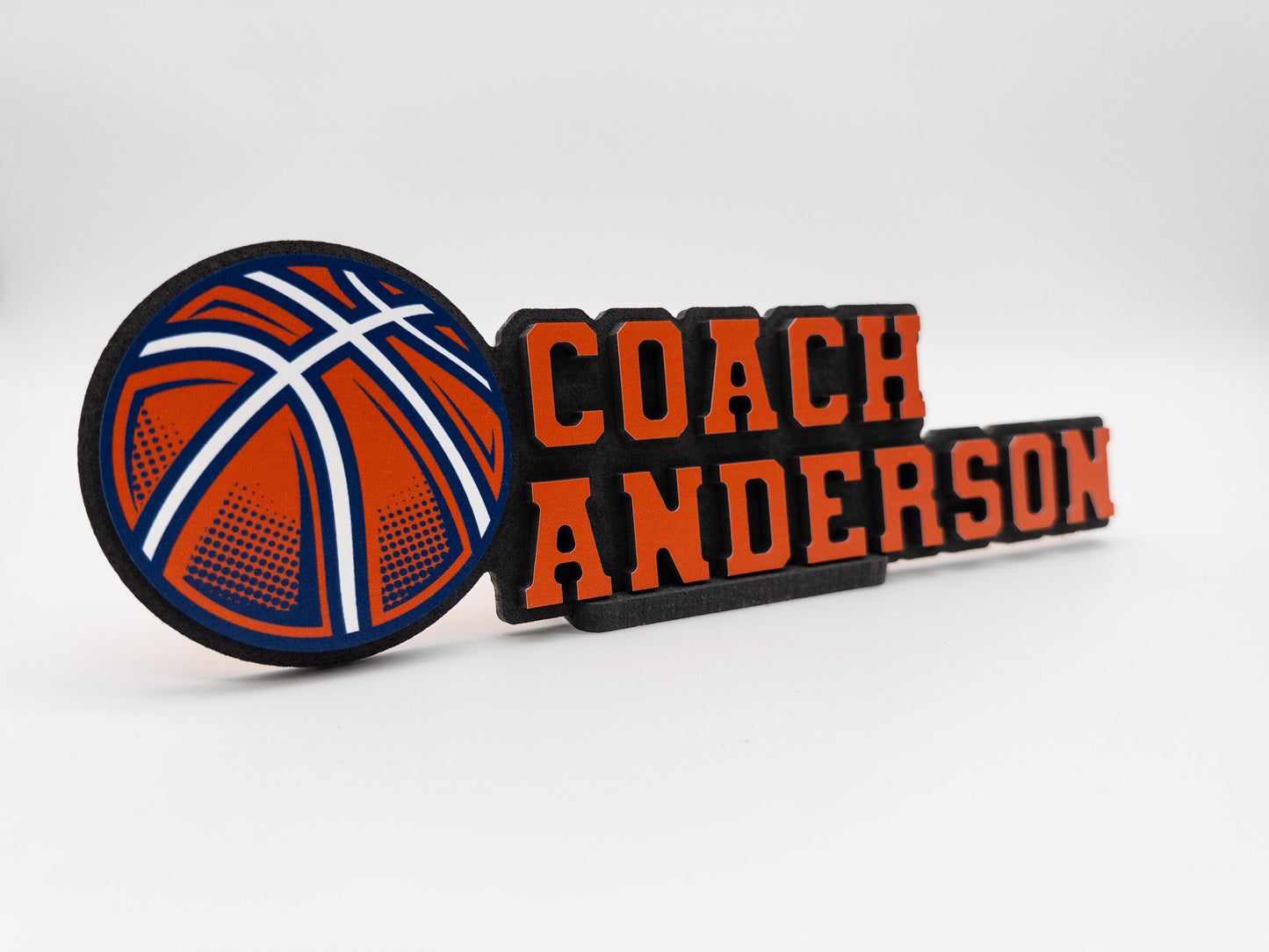 Personalized nameplate for Coach Anderson featuring a detailed basketball illustration, ideal for office use.