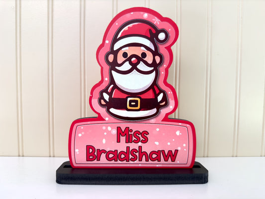 Close-up view of the Santa desk name sign showcasing its bright red design and cute Santa figure with a festive look.